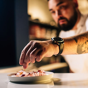 chef arranging food on plate