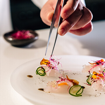 chef arranging food on plate