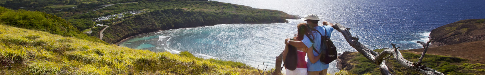 Couple on a mountainside looking over the ocean
