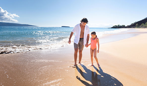 family walking on beach Hawaii Island