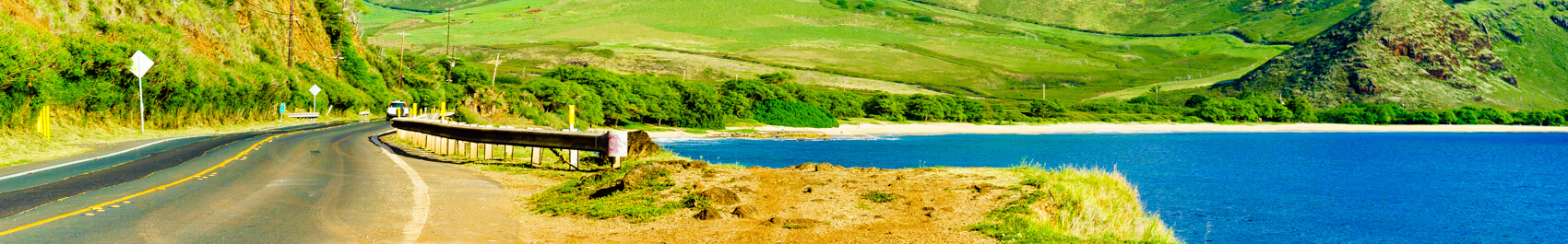 Car driving on the road along the coast of the North Shore