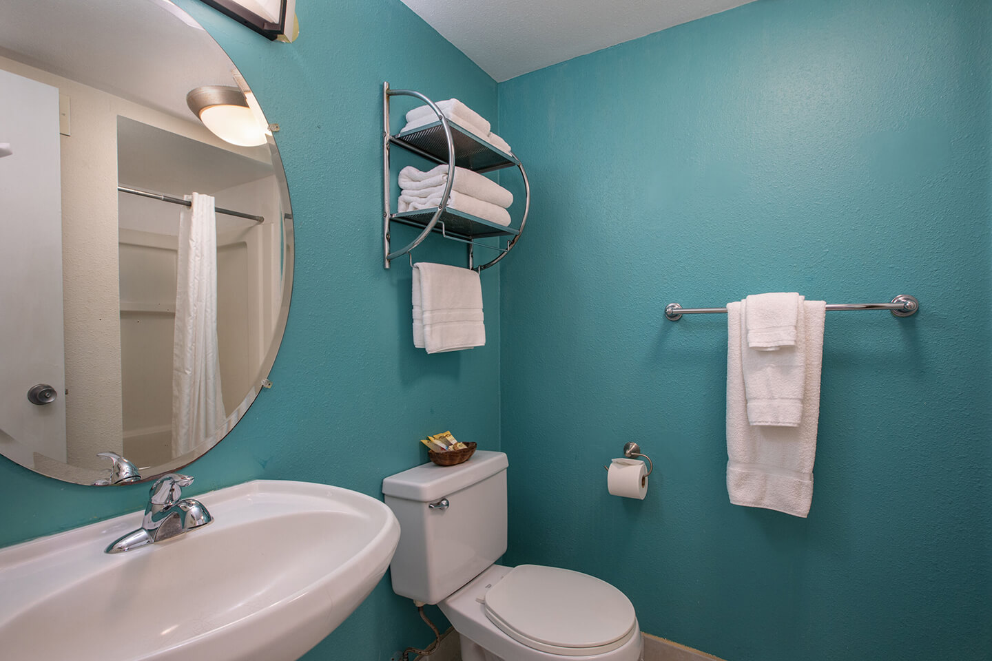 Bathroom with a sink, toilet, and towels.