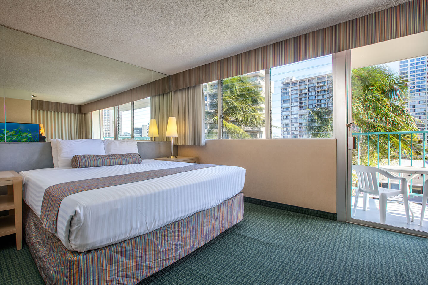 Room with a bed and balcony.