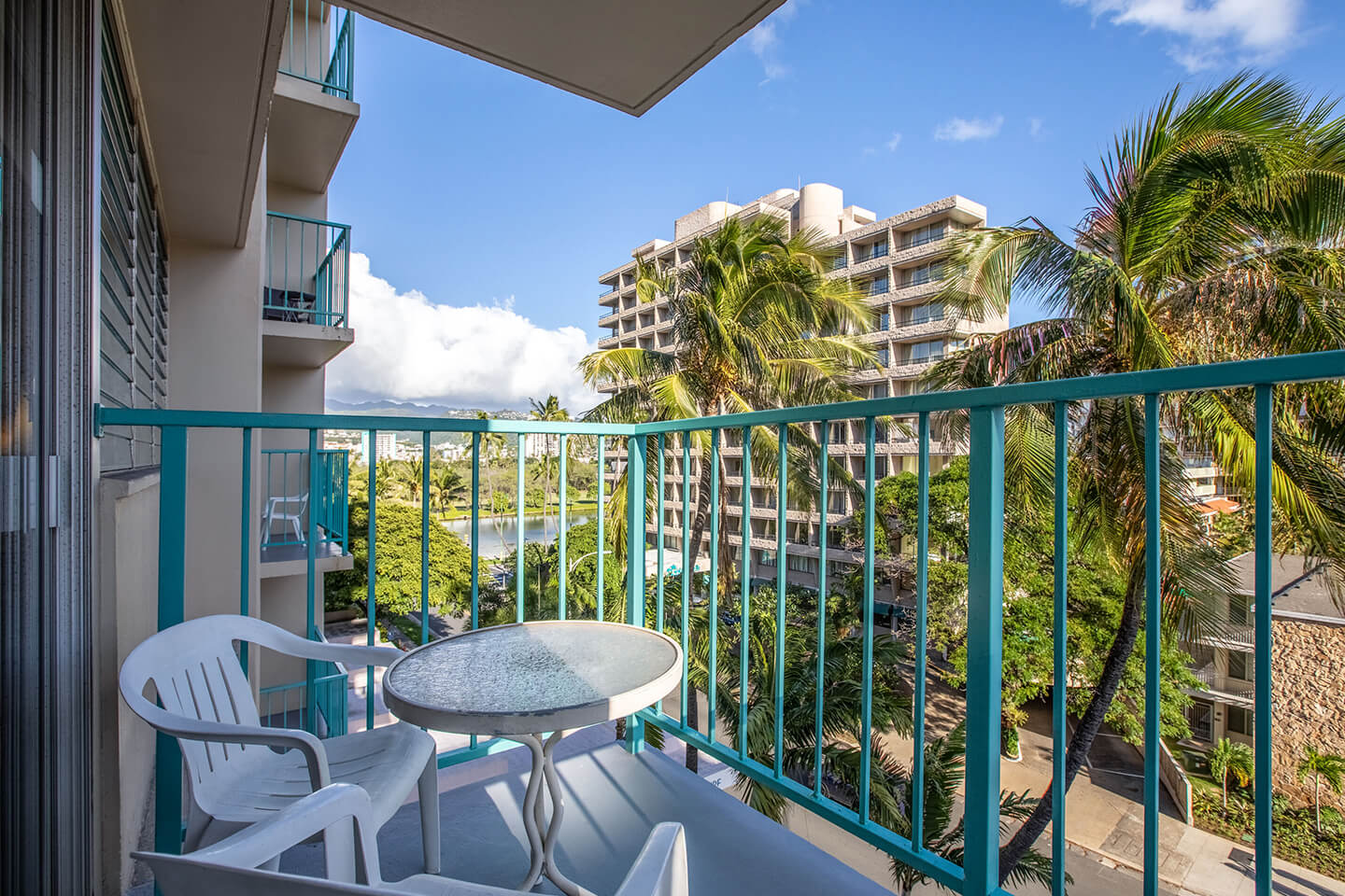 Balcony with 2 chairs and view overlooking Waikiki. 
