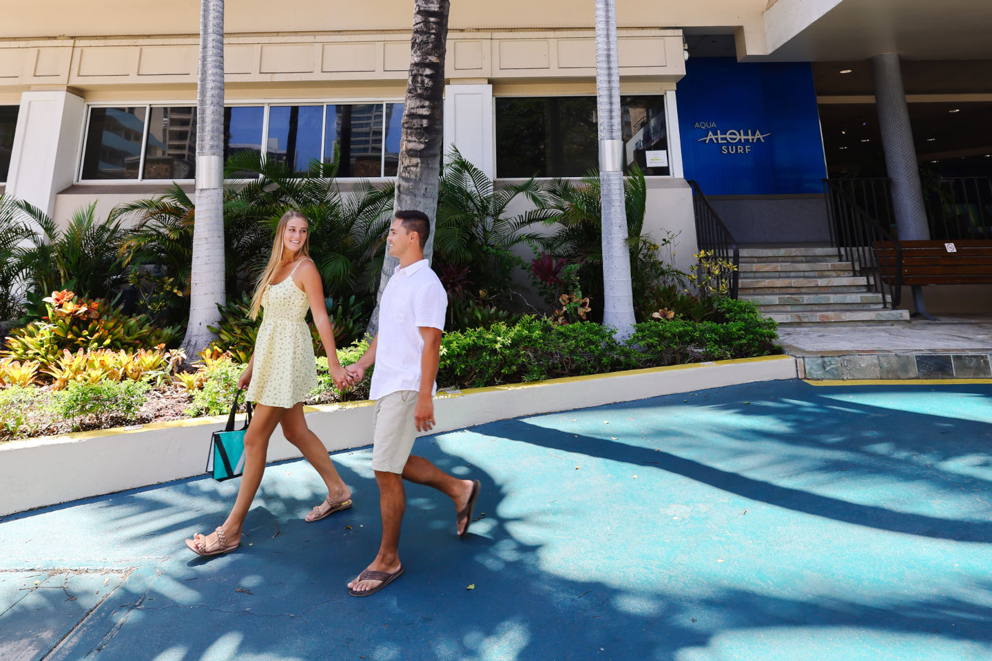 Couple walking near the hotel entrance.