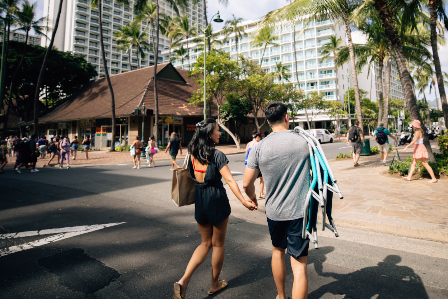 Couple walking through streets in Waikiki.