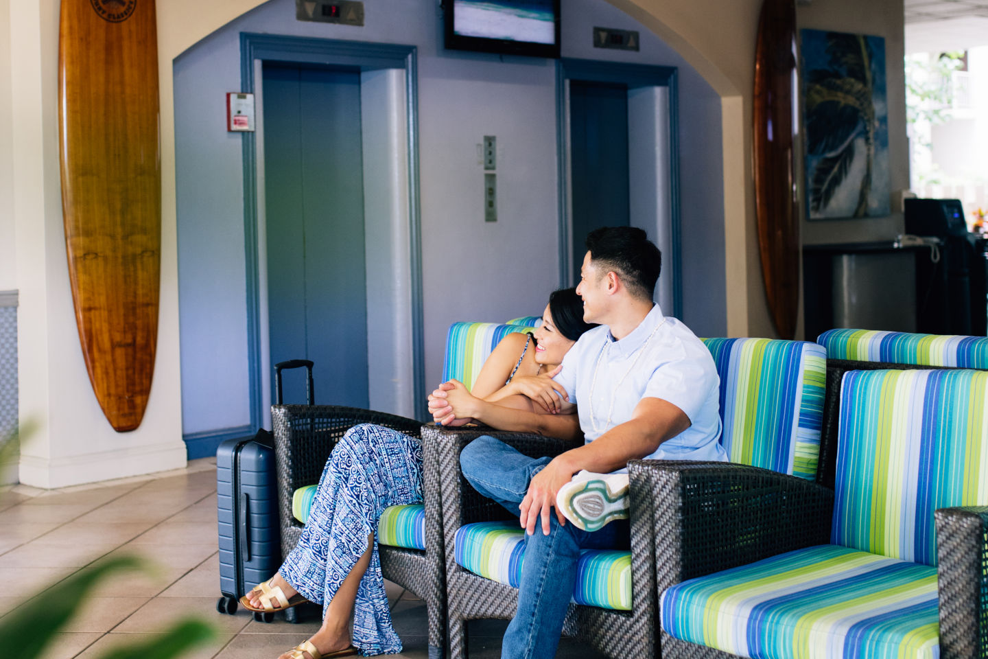 Couple relaxing in hotel lobby.