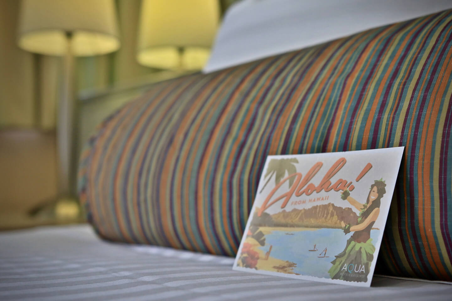 Aloha postcard on pillow.