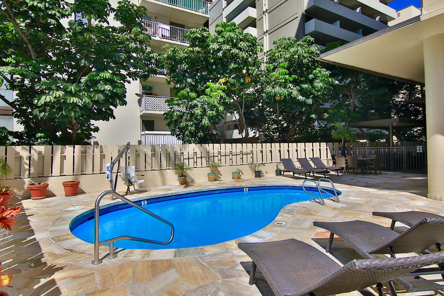 Outdoor pool and sun deck with loungers.