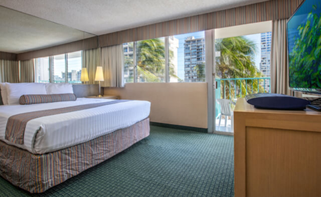 Room with bed, nightstand, lamp, balcony