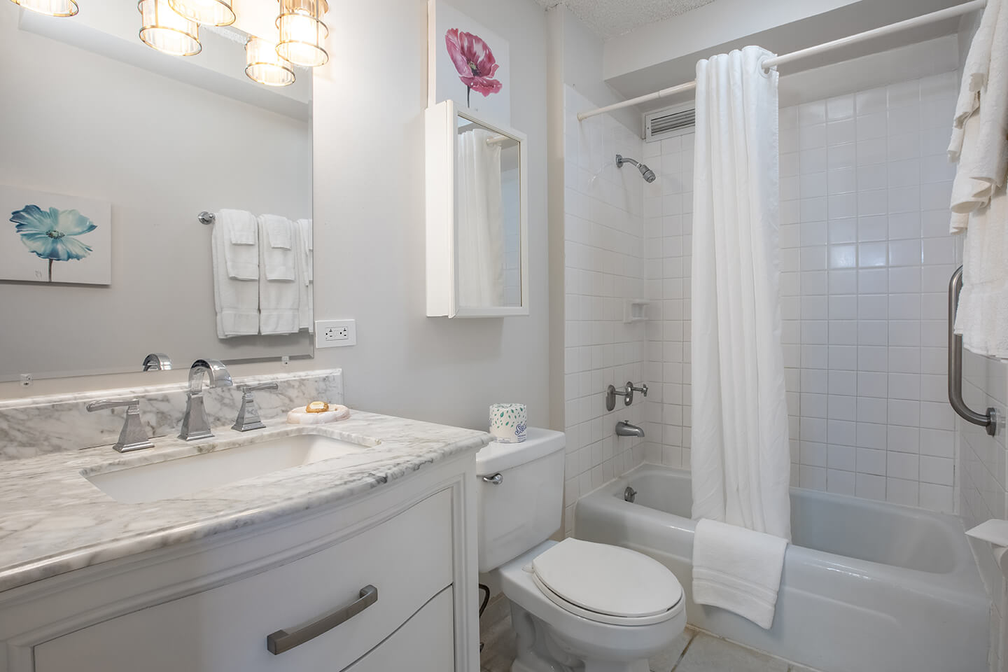 Bathroom with a sink, toilet, shower and tub.