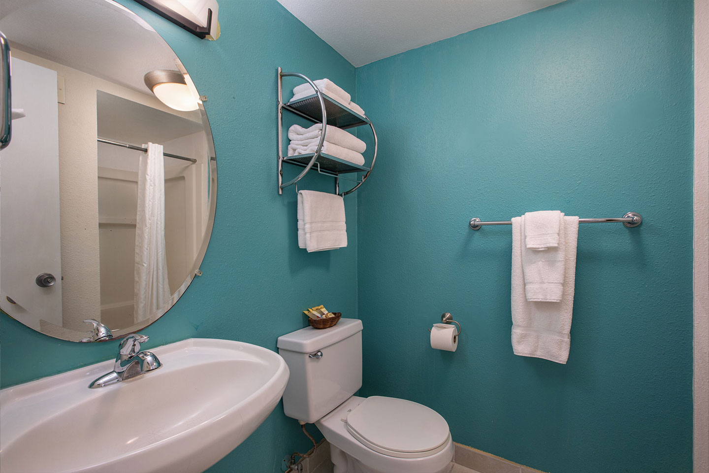 Bathroom with a sink, mirror, and toilet.