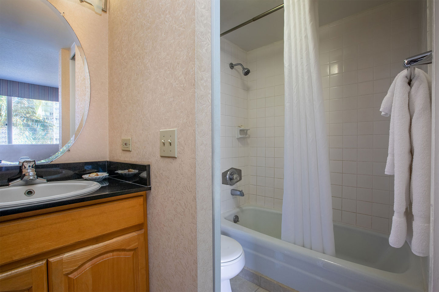 Bathroom with a sink and shower/tub combo.