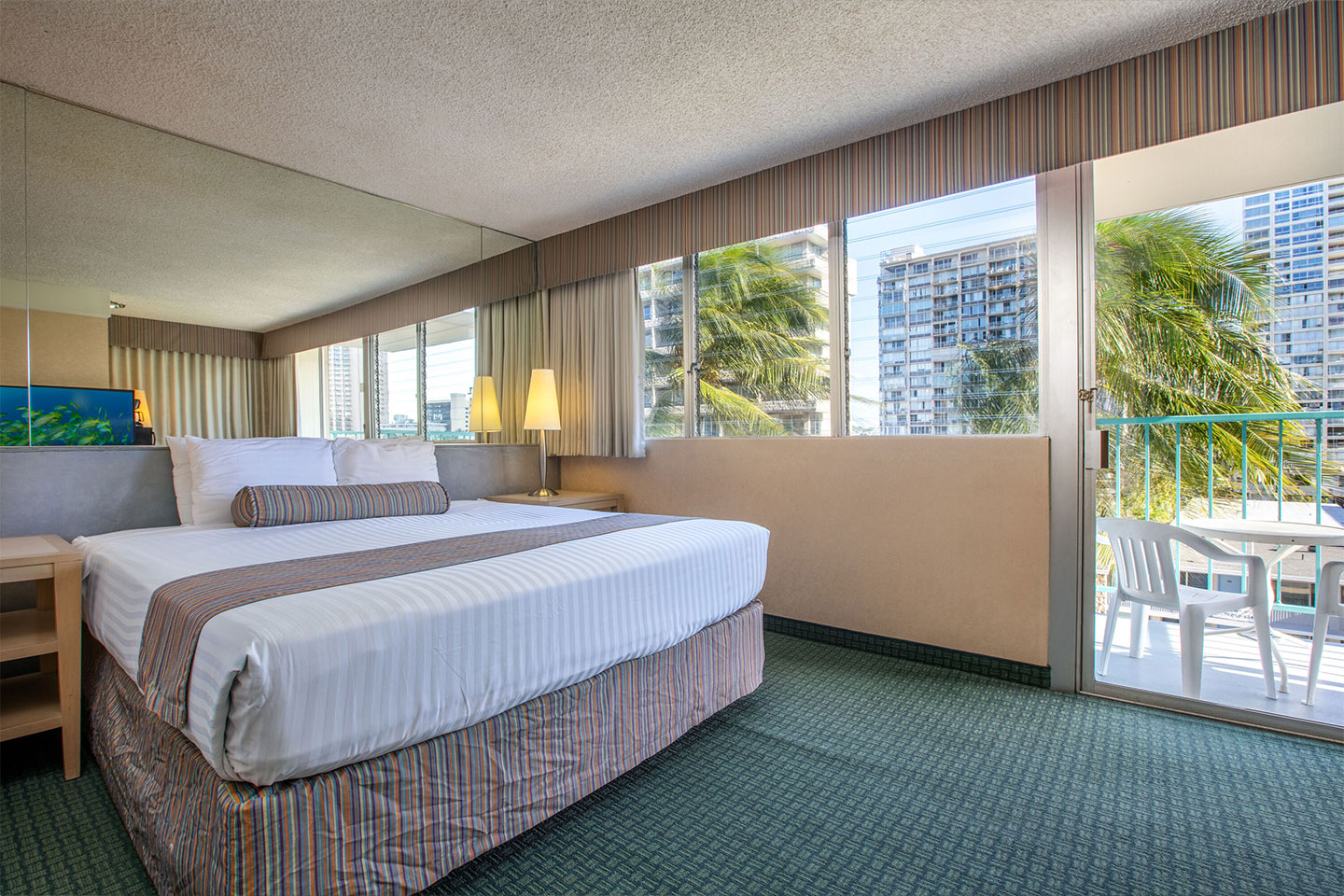 Room with a bed and balcony.