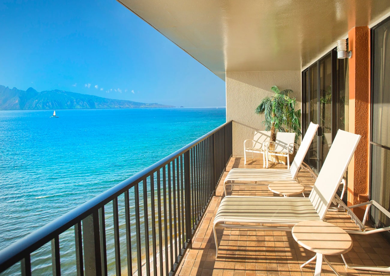 Balcony with lounge chairs and ocean view.