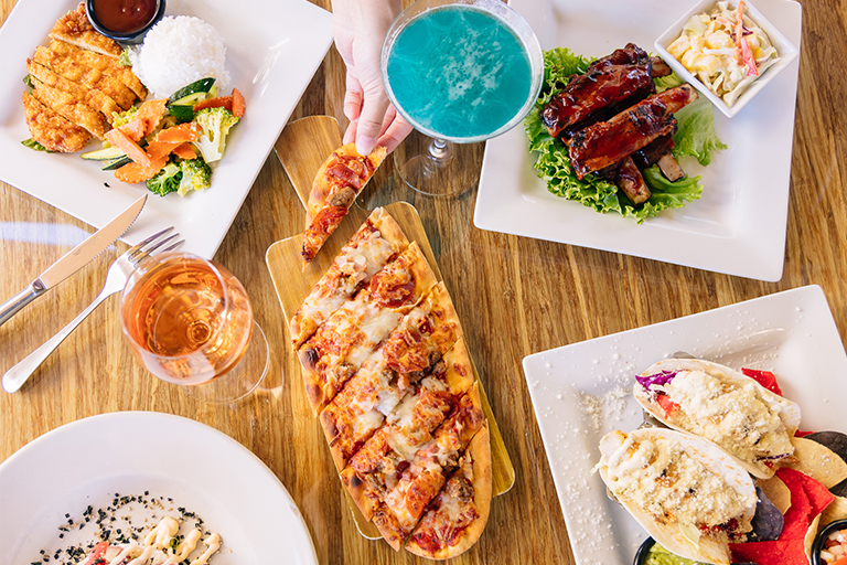 Various dishes of chicken, flat bread, drinks, etc