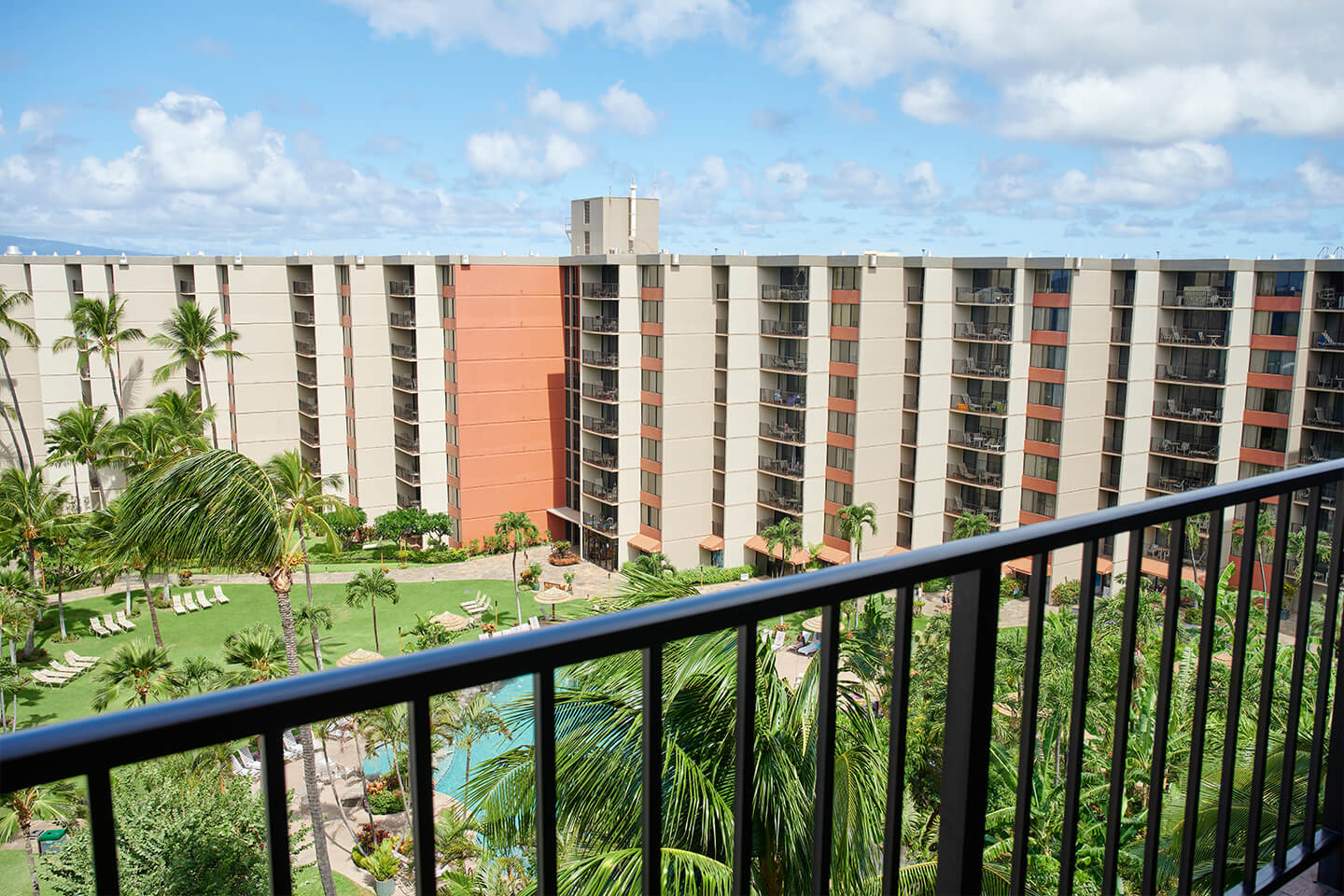 Balcony view of pool and resort.