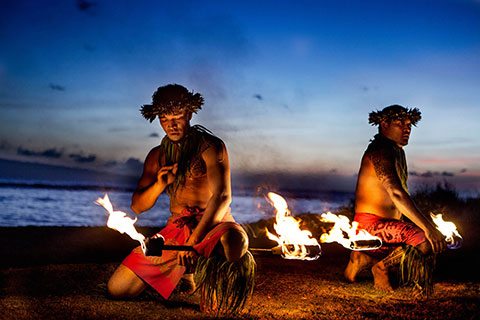 2 pfire dancers at luau.