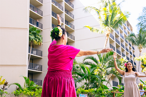 Two women dancing hula
