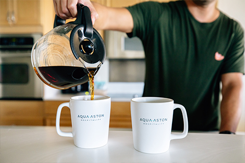 Man pouring coffee into mug