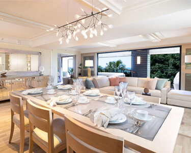 Dining room with a table, chairs, and balcony.