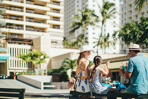 Family sitting on a bench in Waikiki