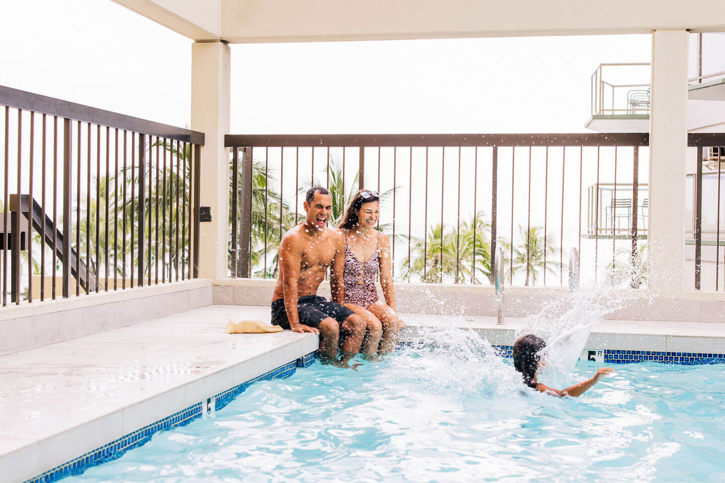 Family playing in pool