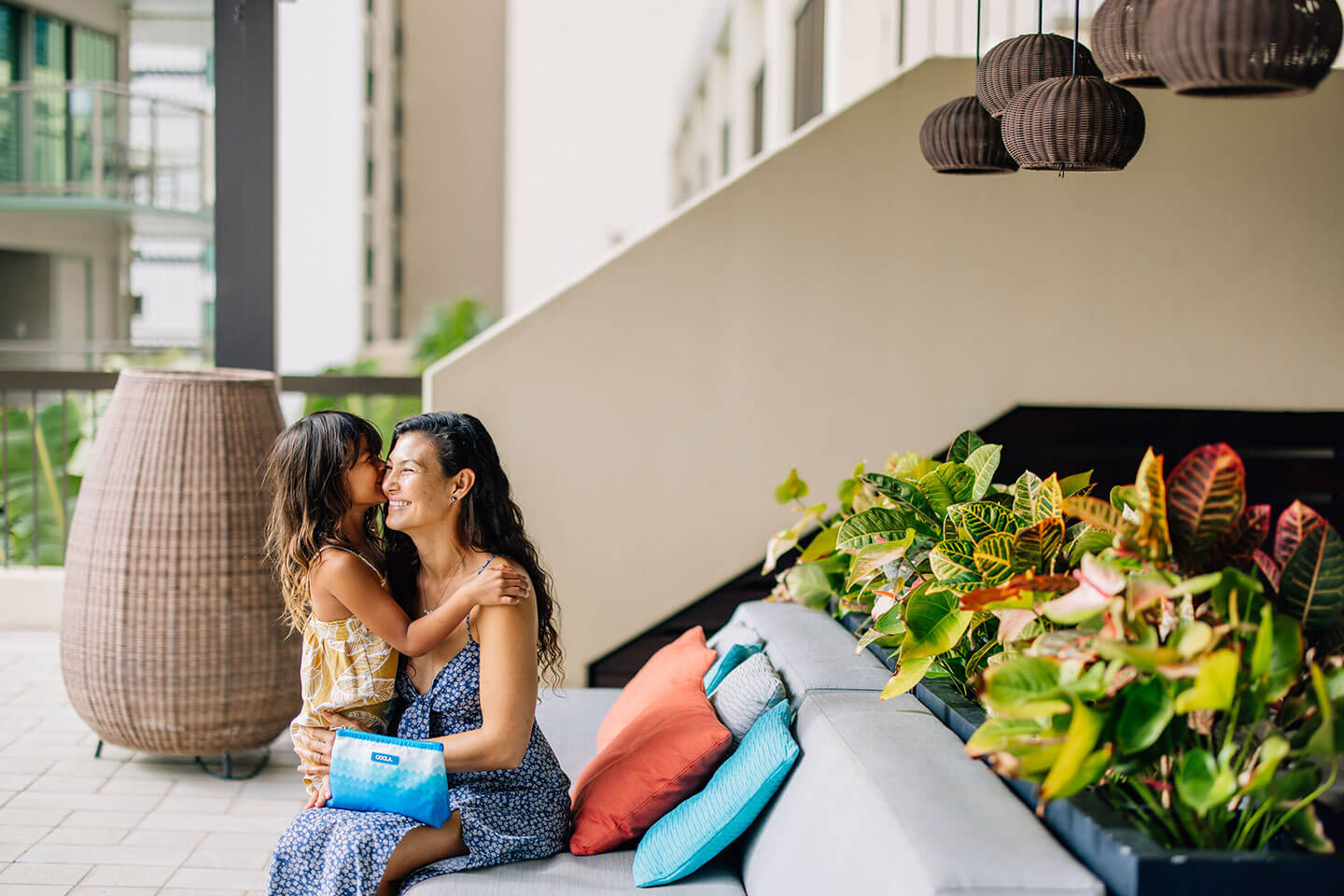 Mother and daughter sitting on outdoor seats