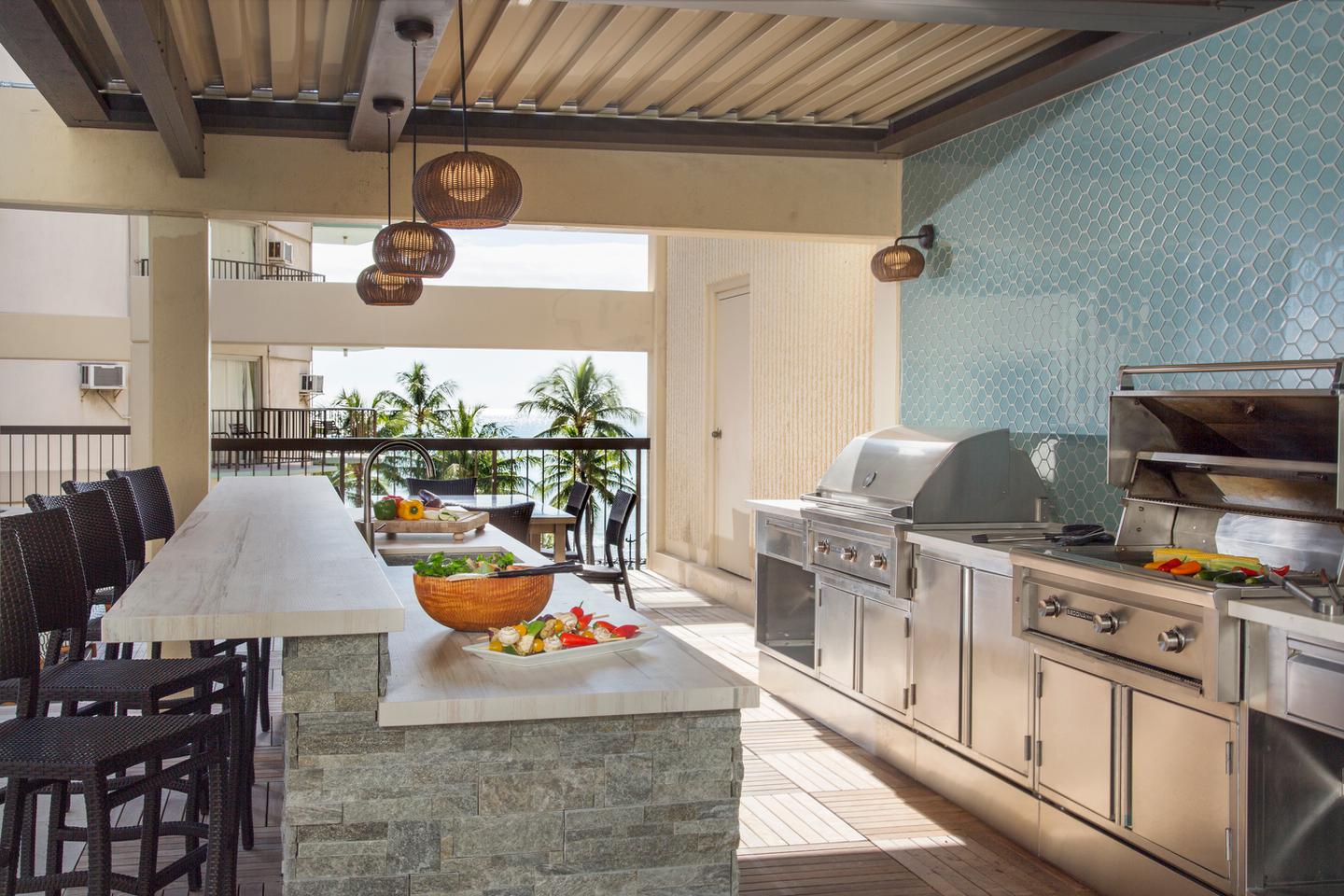 Outdoor barbecue grills, sink,  and counter for dining