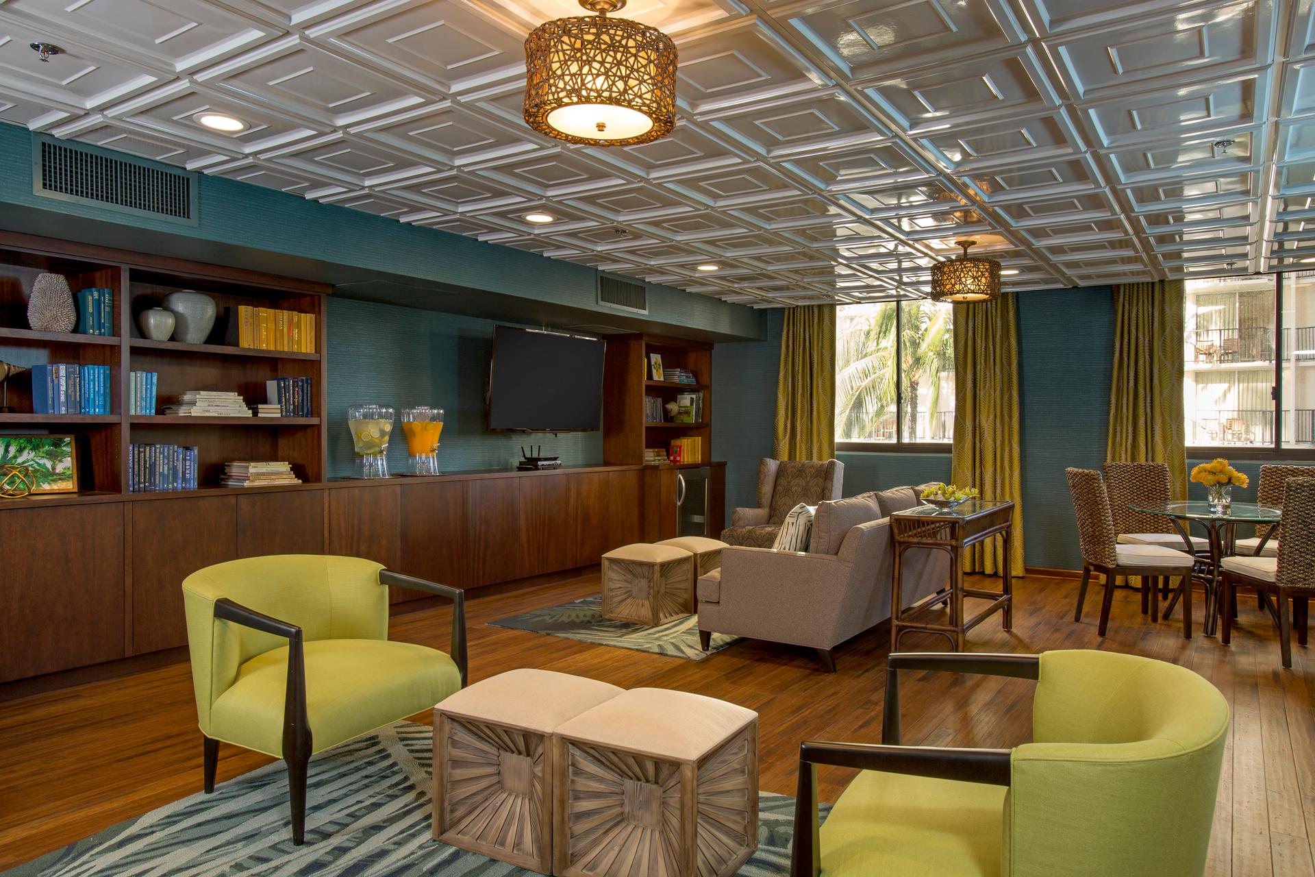 Spacious room with open seating, tables, and TV