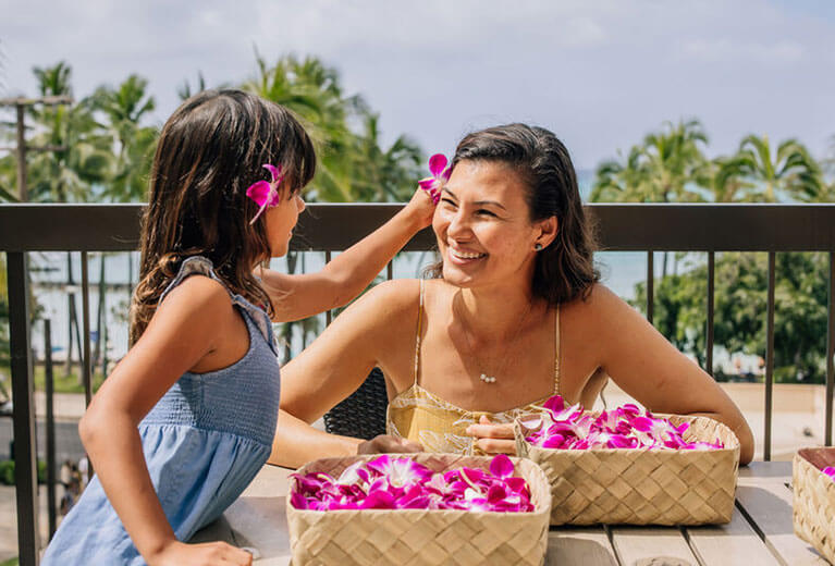 Woman and daughter with flowers on deck