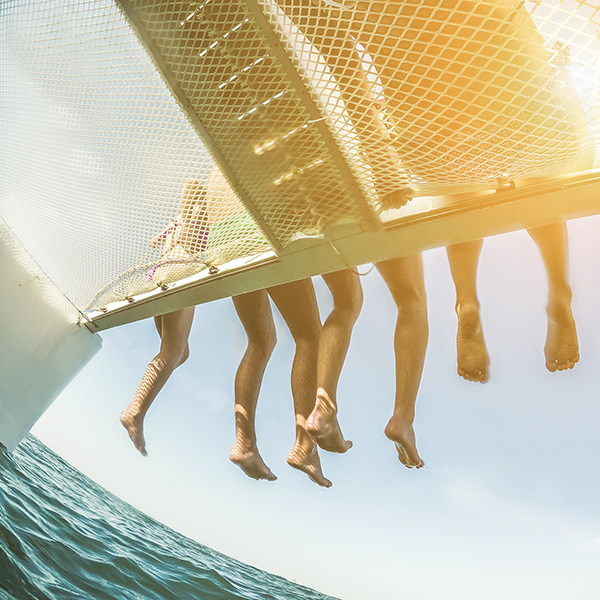 Friends on a catamaran at sunset in Waikiki beach Oahu Hawaii