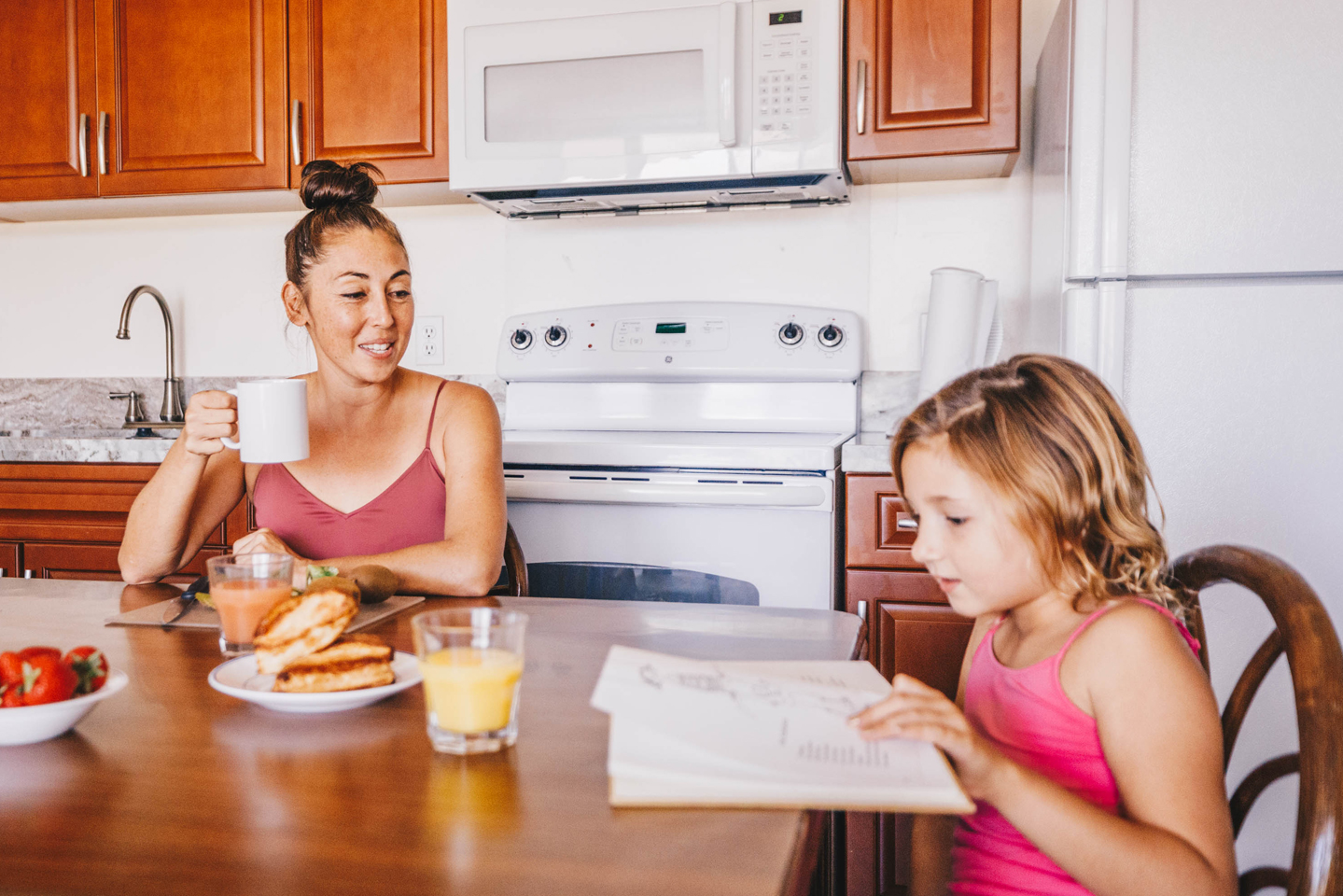 Mother and daughter having a meal in the kitchen.
