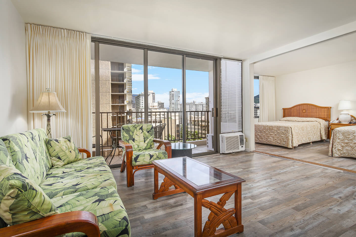 1-Bedroom Standard Suite with living area overlooking a private balcony and bedroom.