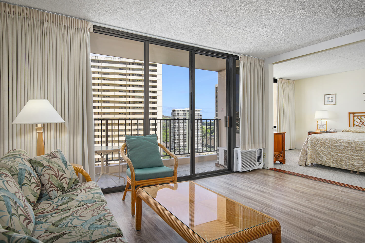 1-Bedroom Superior Suite living area with sofa, bedroom, and view