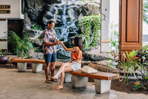 Man and woman having coffee in lobby.