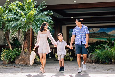 Family walking in front of hotel.