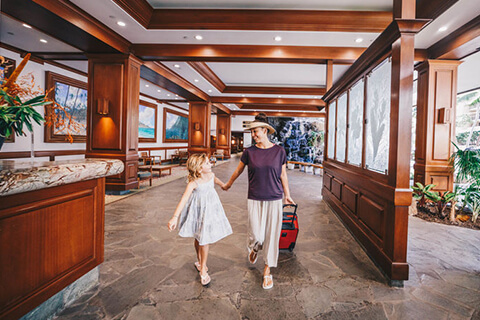 Mother and daughter walking through lobby.