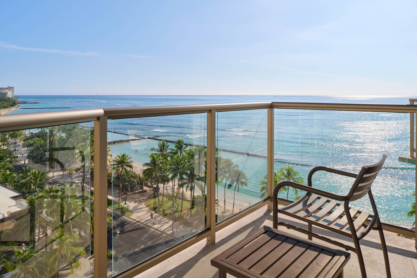 Balcony with a table, chair, and oceanfront view.