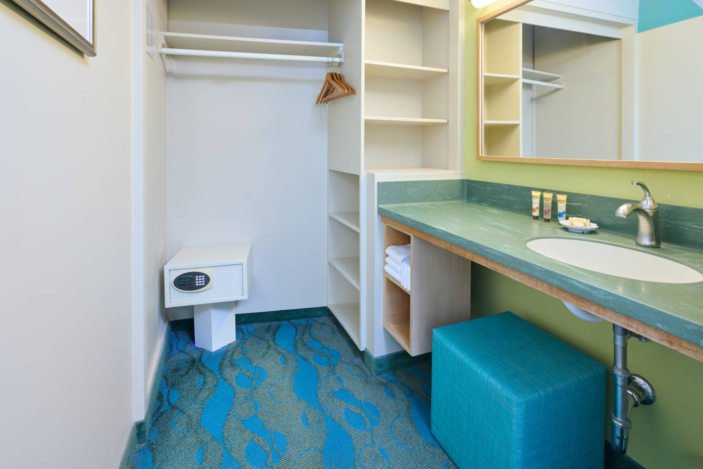 Sink and closet with bath amenities in accessible room at Aston Waikiki Circle Hotel