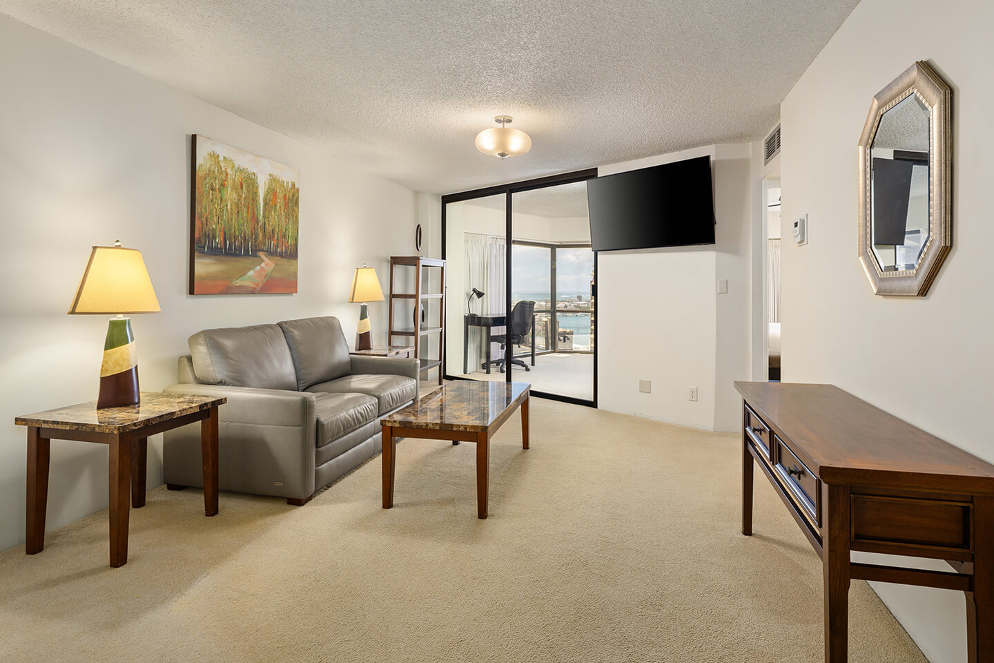Living area with couch, seating, table, and TV.