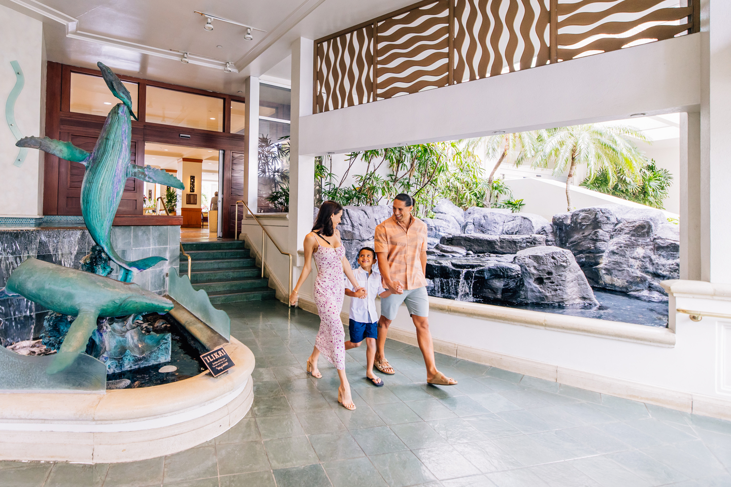 Family walking through hotel lobby.