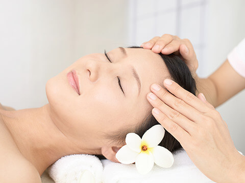 Woman receiving face massage.