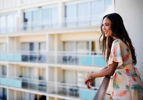 woman looking at view off balcony 