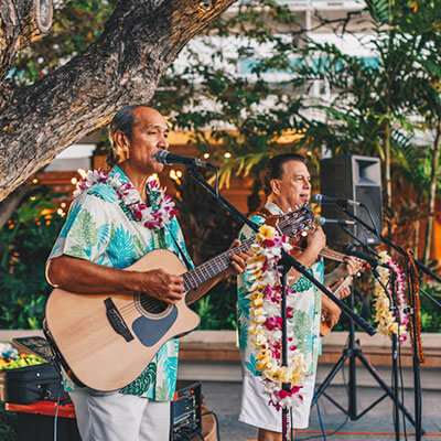 Musicians perform on outdoor patio.