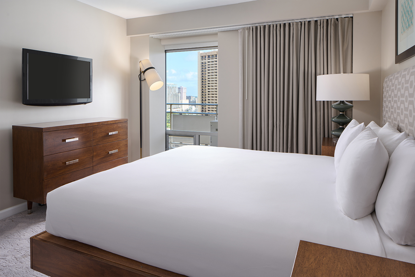 Bedroom with bed, TV, night stands and lamps