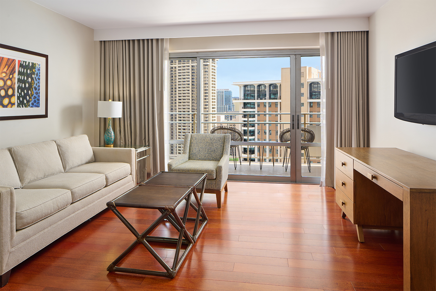 Living area with couch, TV, coffee table, and balcony