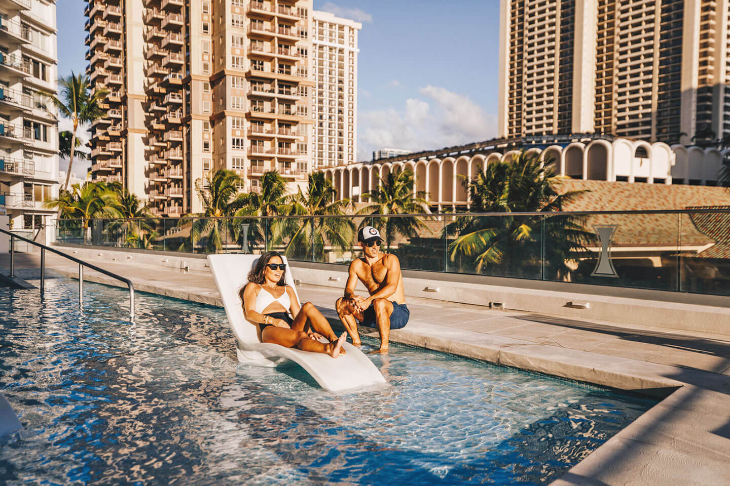 Couple relaxing in hotel pool.