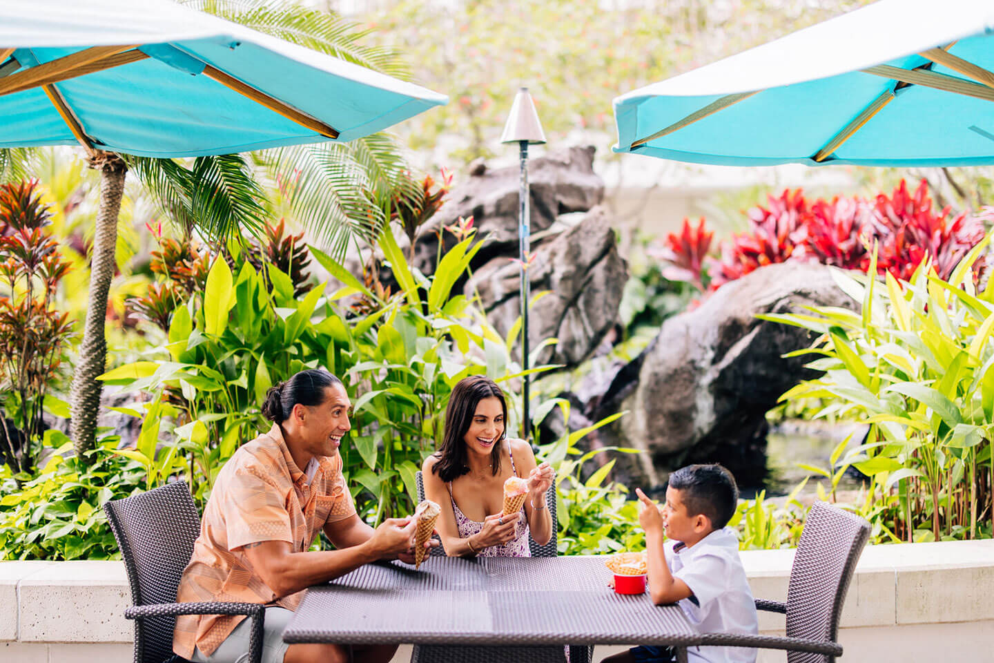 Family enjoying ice cream in outdoor cortyard.