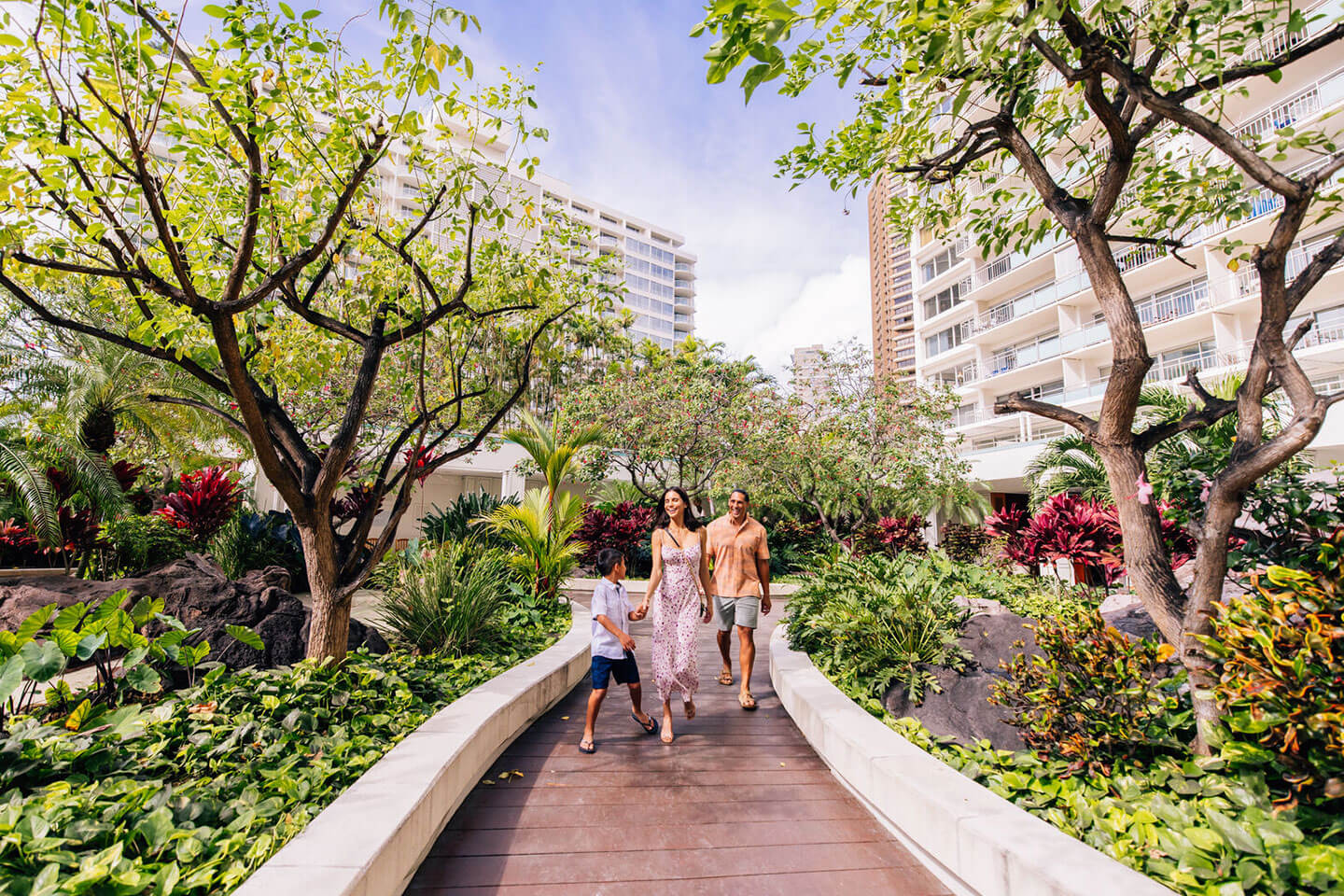 Family walking through hotel courtyard.